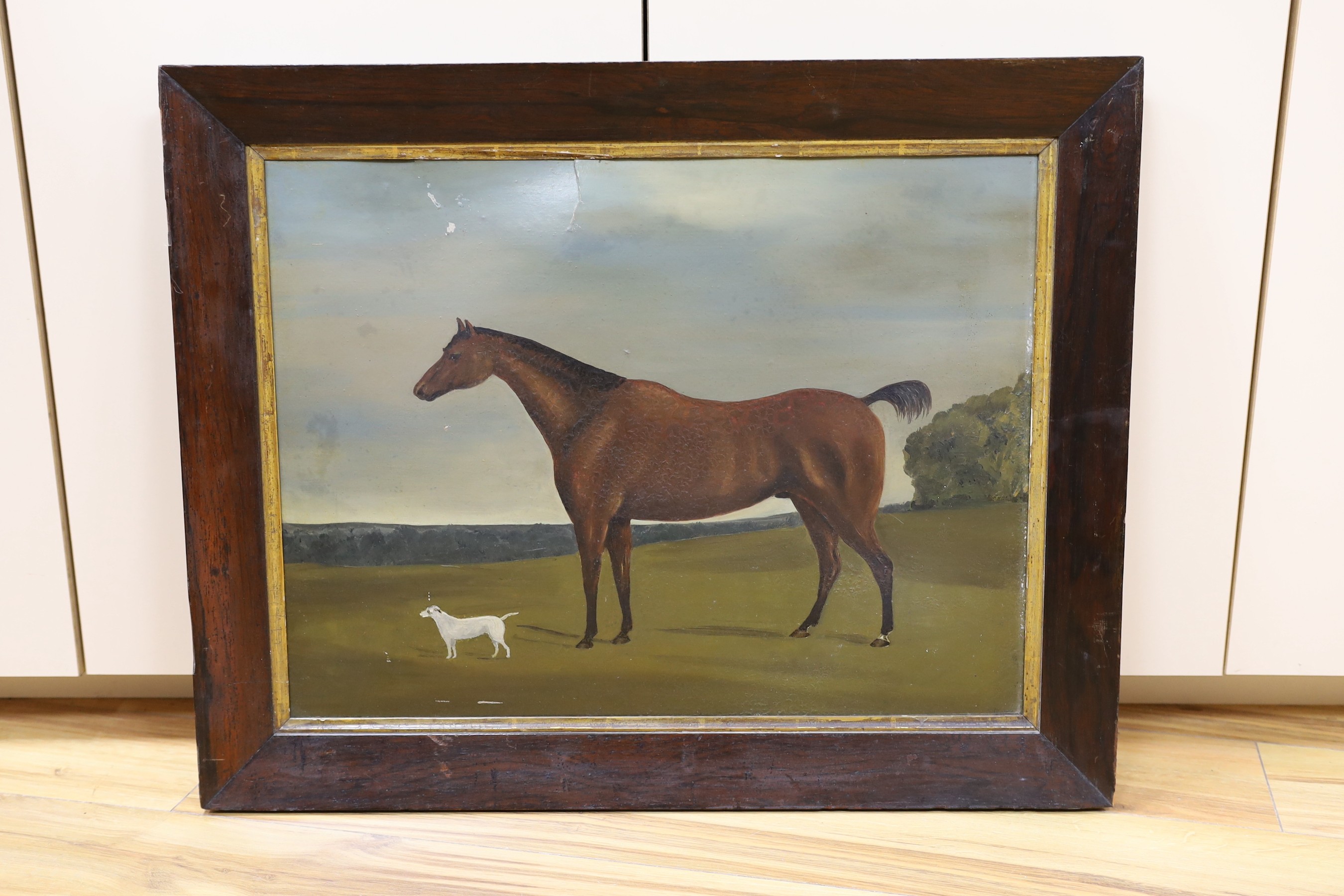 19th century English School, oil on card, Primitive study of a horse and terrier in a landscape, 46 x 60cm